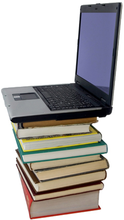 Laptop on top of pile of books